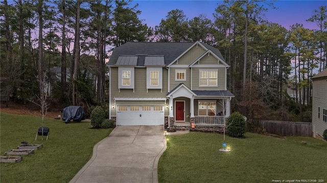 63 Slate Dr, Spring Lake, NC 28390 - craftsman house with concrete driveway, an attached garage, a porch, a front lawn, and stone siding