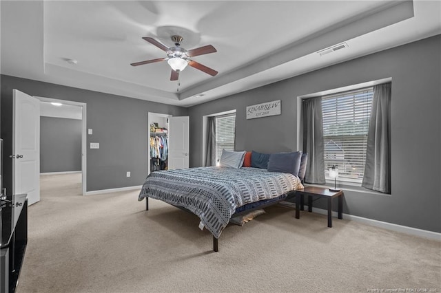 63 Slate Dr, Spring Lake, NC 28390 - bedroom featuring a tray ceiling, light carpet, and baseboards