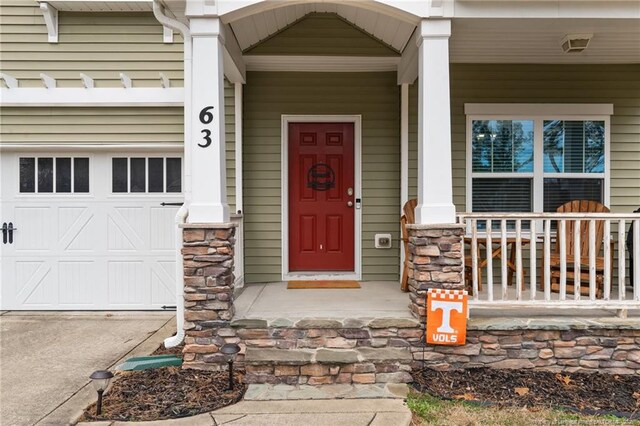 63 Slate Dr, Spring Lake, NC 28390 - entrance to property with covered porch and a garage