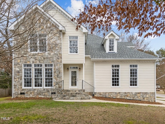 view of front of home featuring crawl space, stone siding, a front yard, and a shingled roof