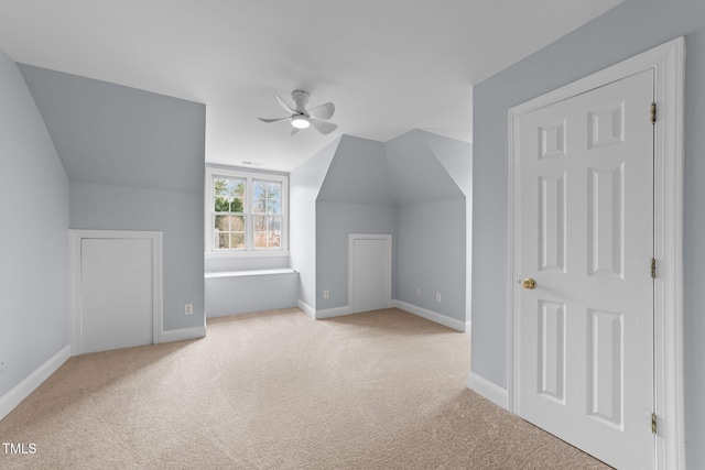 additional living space with vaulted ceiling, carpet, baseboards, and ceiling fan