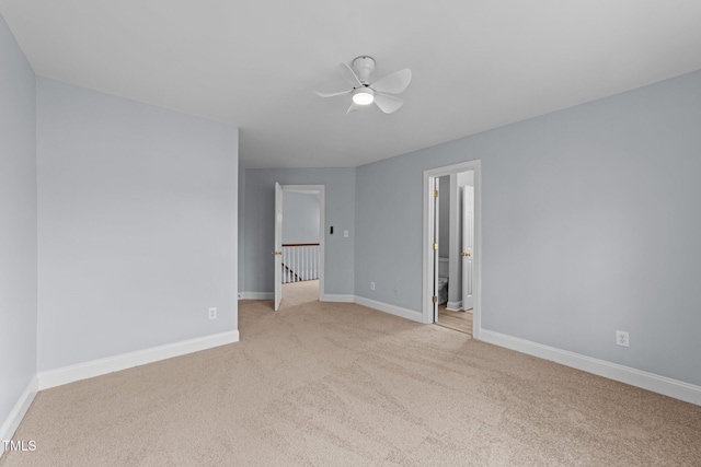 unfurnished bedroom featuring light colored carpet and baseboards