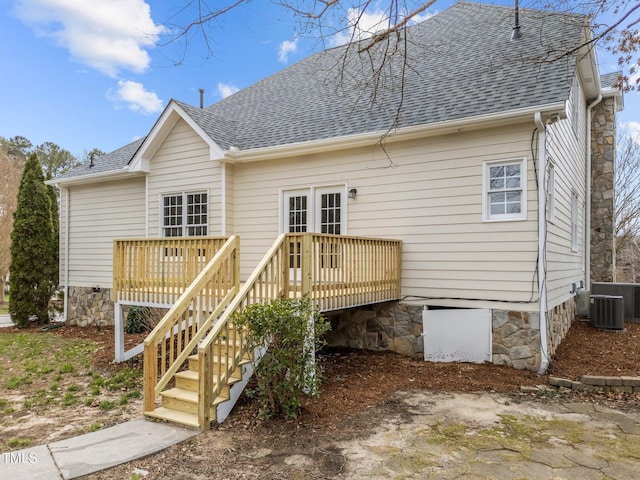 back of house featuring a deck, stairs, and a shingled roof