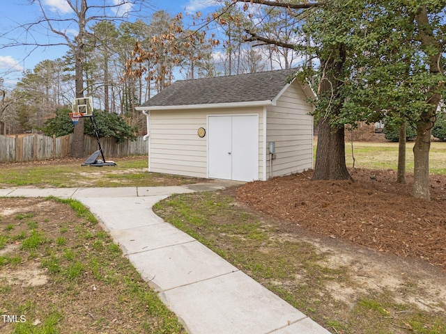 view of outdoor structure with an outbuilding and fence