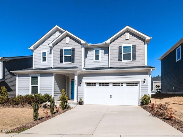 view of front of home with concrete driveway and a garage