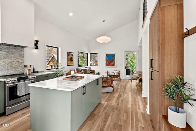 kitchen with ventilation hood, electric stove, light wood finished floors, and a kitchen island