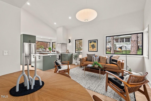 dining area featuring recessed lighting and high vaulted ceiling