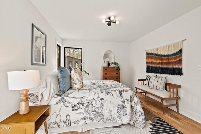 bedroom featuring baseboards and wood finished floors