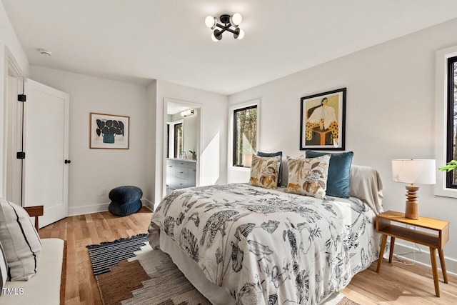 bedroom featuring light wood-style flooring and baseboards