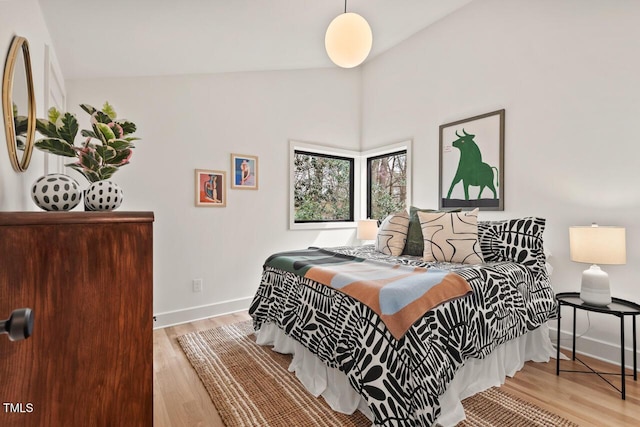 bedroom with light wood-style floors and baseboards