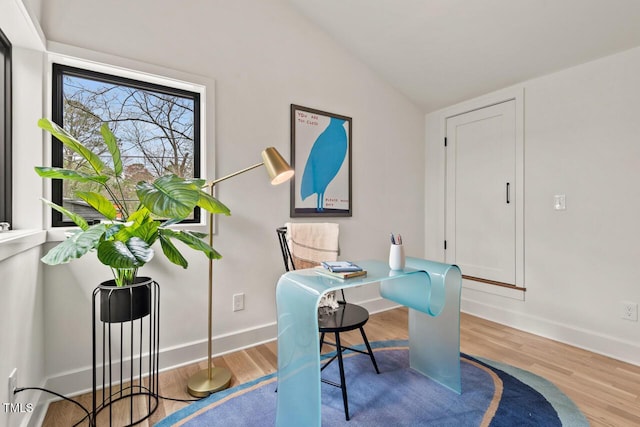 office area with vaulted ceiling, wood finished floors, and baseboards