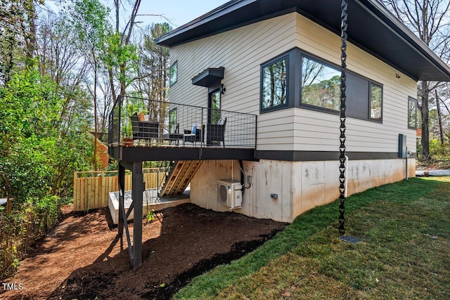 view of side of home featuring a lawn, stairs, a deck, and ac unit