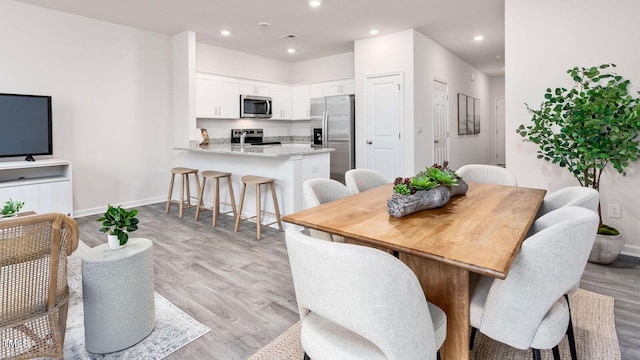 dining space featuring visible vents, recessed lighting, baseboards, and light wood-type flooring