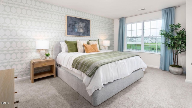 bedroom featuring carpet flooring, visible vents, wallpapered walls, and baseboards