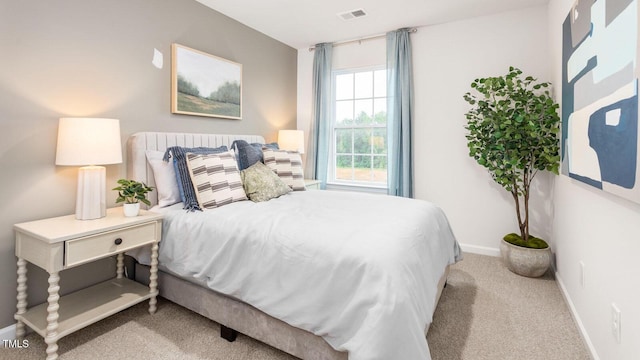 bedroom featuring visible vents, baseboards, and carpet