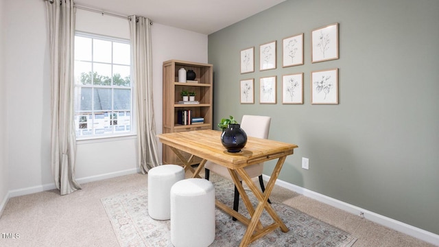 home office featuring carpet, baseboards, and a wealth of natural light