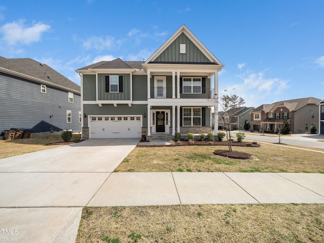 view of front of house featuring board and batten siding, a front lawn, concrete driveway, a balcony, and an attached garage