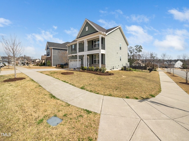 traditional-style home with a residential view, a front lawn, board and batten siding, and an attached garage