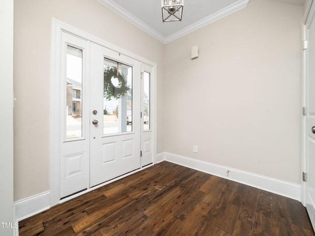 foyer entrance featuring a chandelier, dark wood-style flooring, baseboards, and ornamental molding