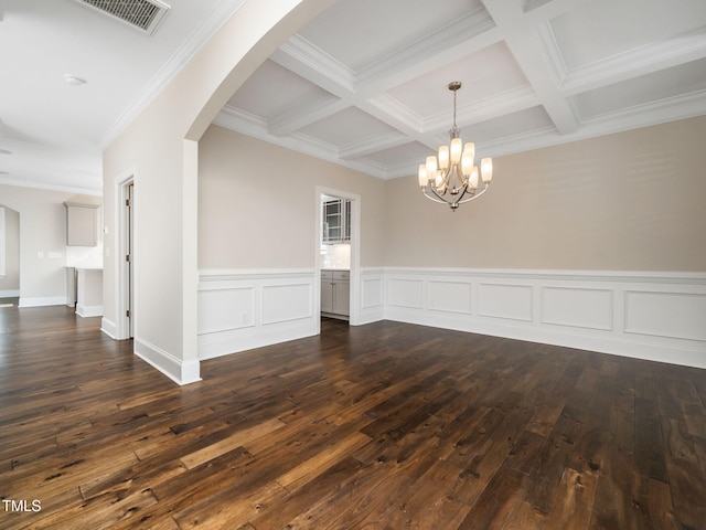 unfurnished room with beam ceiling, an inviting chandelier, arched walkways, coffered ceiling, and dark wood-style flooring