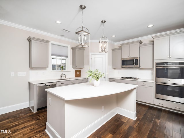 kitchen with visible vents, a center island, light countertops, gray cabinets, and appliances with stainless steel finishes