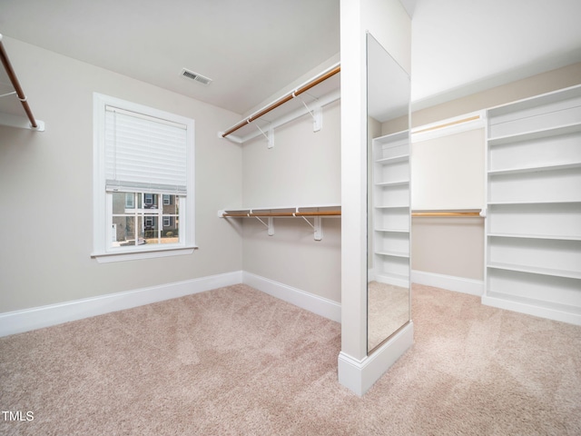 walk in closet featuring visible vents and carpet floors