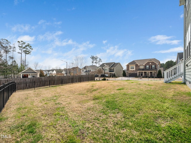 view of yard featuring a fenced backyard and a residential view