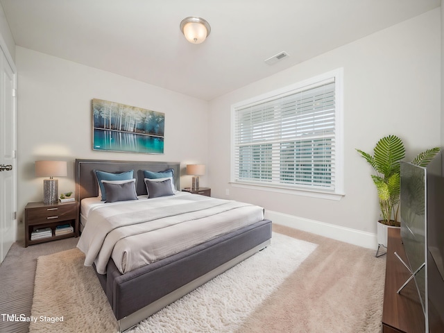 bedroom with visible vents, baseboards, and carpet floors