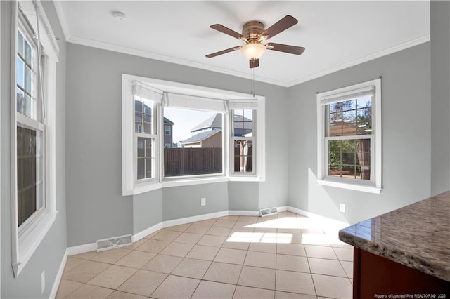 unfurnished dining area featuring a wealth of natural light, visible vents, and ornamental molding