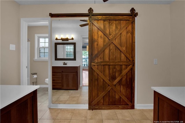 bathroom featuring tile patterned floors, toilet, vanity, and baseboards