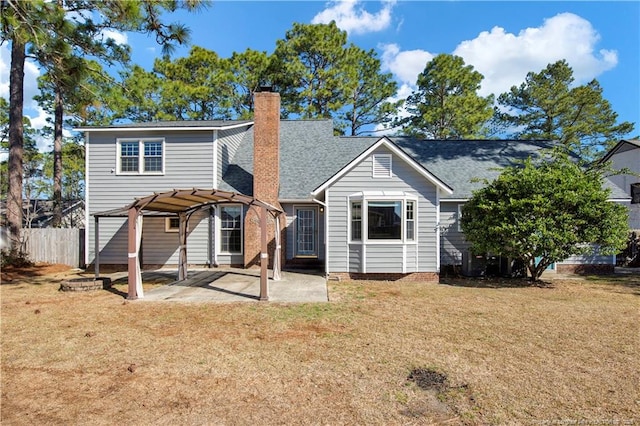 rear view of property with fence, a lawn, a chimney, a patio area, and a pergola