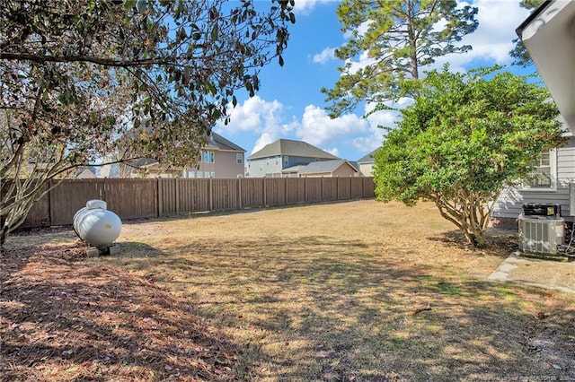 view of yard featuring central AC unit and a fenced backyard