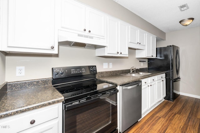 kitchen with black appliances, white cabinets, dark countertops, and under cabinet range hood