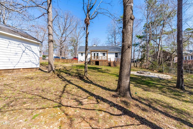 view of yard with a deck and fence