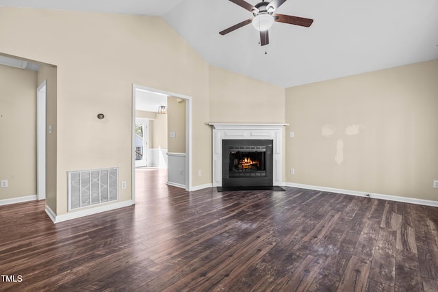 unfurnished living room featuring a ceiling fan, dark wood-style floors, visible vents, baseboards, and a fireplace with flush hearth