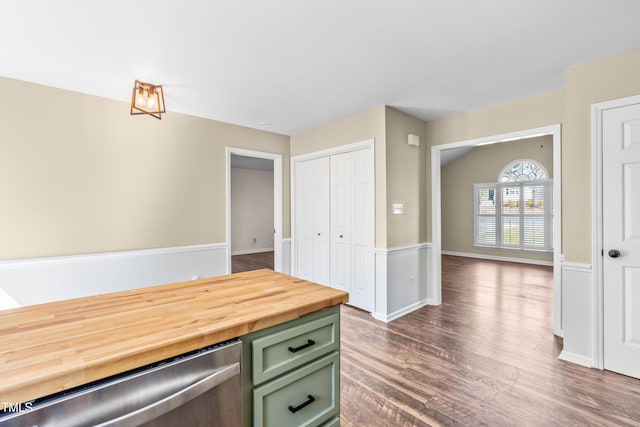 kitchen with green cabinets, dishwasher, and dark wood finished floors