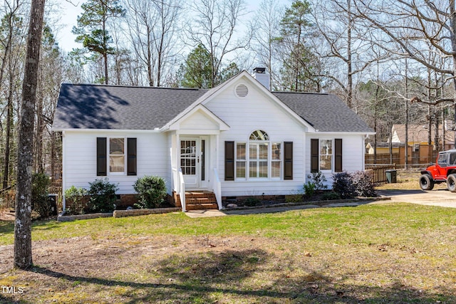 ranch-style home with fence, roof with shingles, a front yard, crawl space, and a chimney