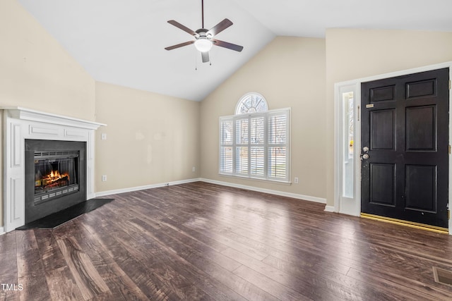 unfurnished living room featuring a fireplace with flush hearth, high vaulted ceiling, a ceiling fan, baseboards, and dark wood-style flooring