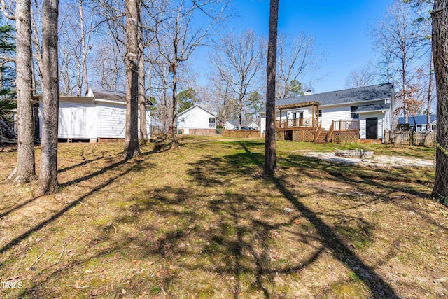 view of yard featuring a deck and fence