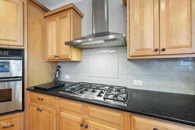 kitchen with light brown cabinets, appliances with stainless steel finishes, tasteful backsplash, and wall chimney range hood