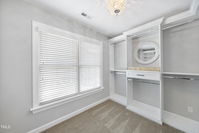 spacious closet with visible vents and light carpet