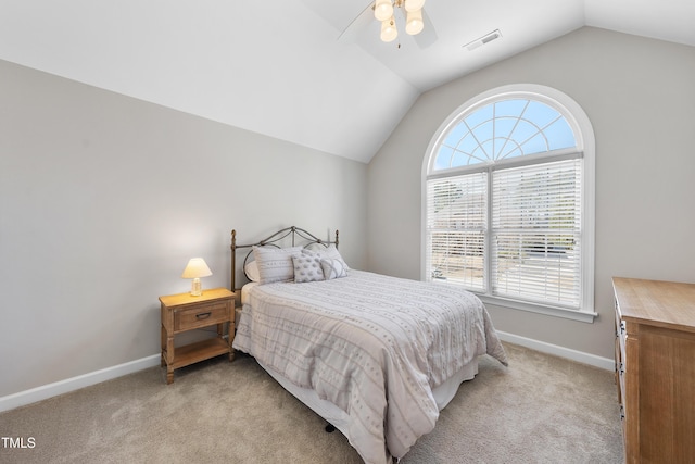 bedroom with vaulted ceiling, baseboards, visible vents, and light carpet