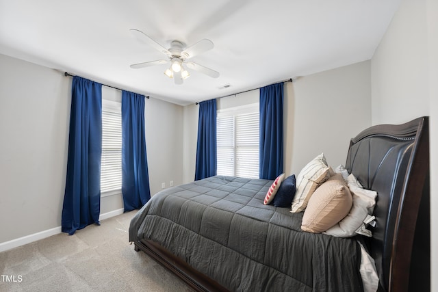 carpeted bedroom with visible vents, ceiling fan, and baseboards