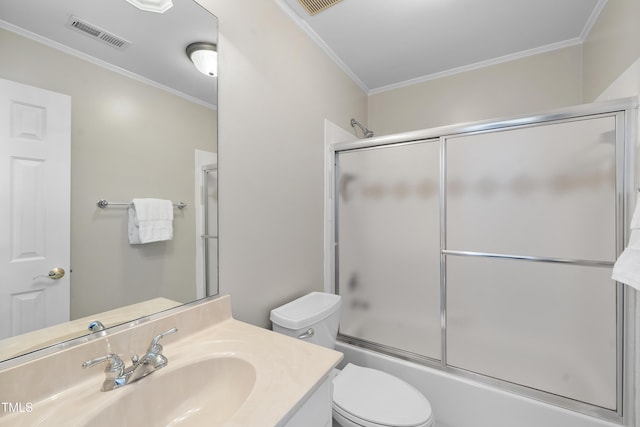 bathroom with visible vents, toilet, crown molding, enclosed tub / shower combo, and vanity