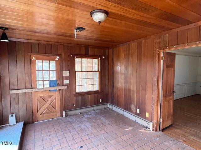 interior space with tile patterned flooring and wood ceiling