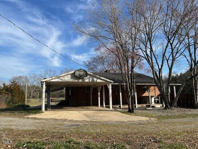 exterior space with a carport and driveway