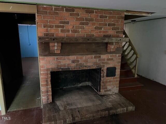 interior details featuring a brick fireplace