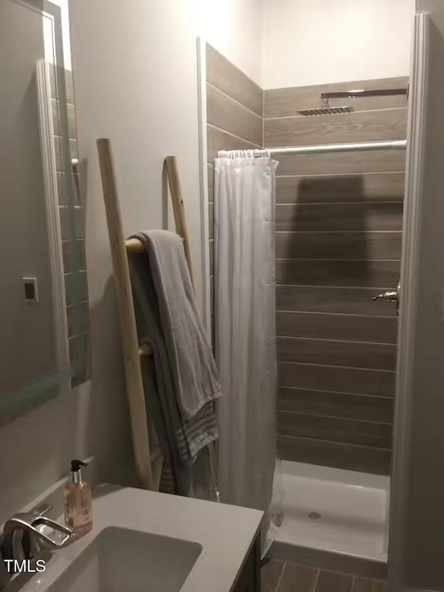 full bathroom featuring vanity and a stall shower