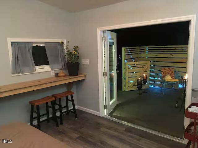 interior space with dark wood finished floors and baseboards