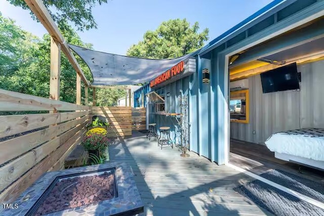 view of patio with a wooden deck and a wall mounted AC